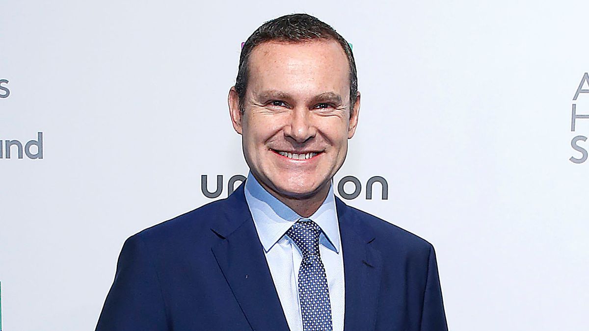 Alan Tacher wearing white shirt tie and  blue coat